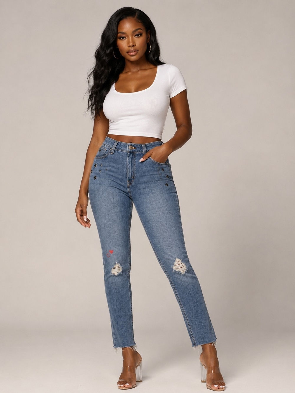 Levi’s 535 Super Skinny raw hem ankle jeans featuring star and heart embroidery.